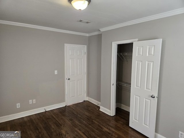 unfurnished bedroom with dark hardwood / wood-style flooring, a closet, and ornamental molding