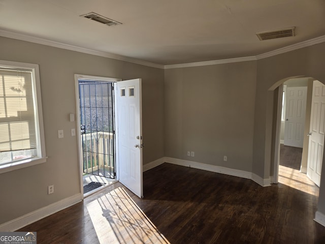 entrance foyer with crown molding, a wealth of natural light, and dark wood-type flooring