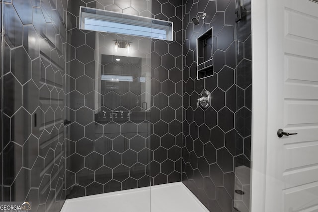 bathroom with a tile shower