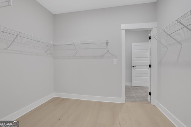 walk in closet featuring light hardwood / wood-style flooring