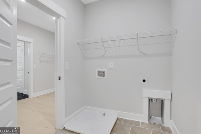 clothes washing area with hookup for an electric dryer, hardwood / wood-style floors, and hookup for a washing machine