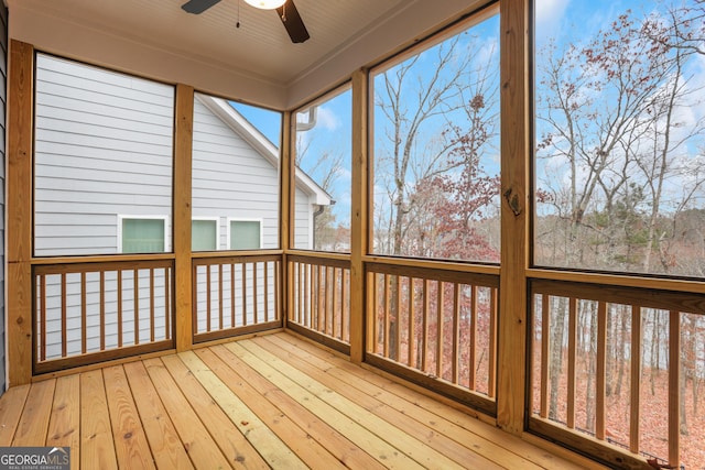 unfurnished sunroom featuring plenty of natural light and ceiling fan