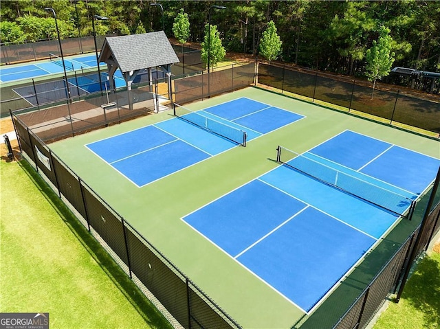 view of tennis court featuring basketball hoop