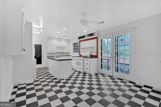 kitchen featuring ceiling fan, french doors, sink, white cabinets, and white stove