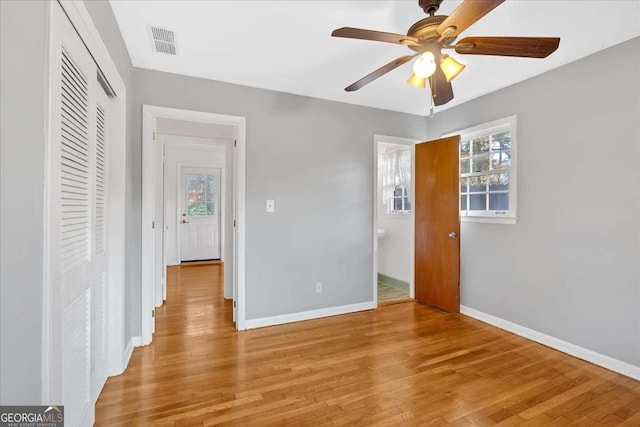 unfurnished bedroom featuring a closet, light hardwood / wood-style floors, and ceiling fan