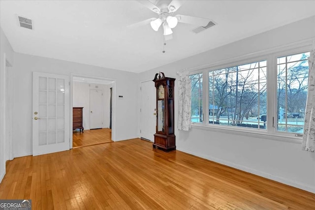 unfurnished living room featuring ceiling fan and light hardwood / wood-style flooring