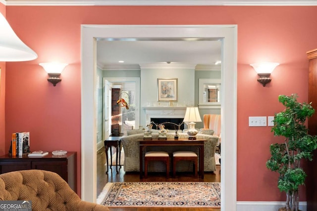 hallway featuring hardwood / wood-style floors and crown molding