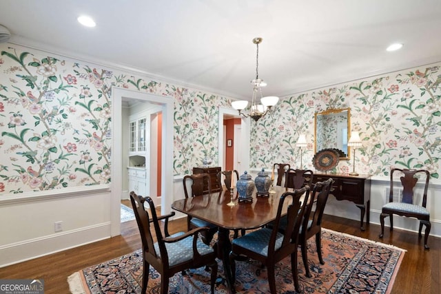 dining room featuring a chandelier, dark wood-type flooring, and ornamental molding