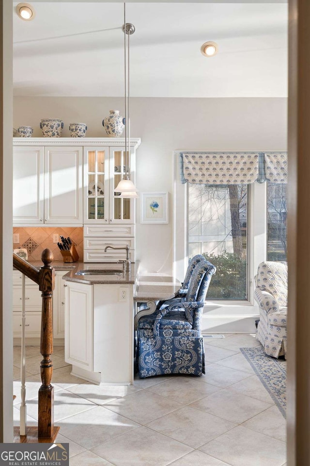 tiled dining room featuring sink