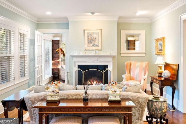 sitting room with hardwood / wood-style flooring and crown molding