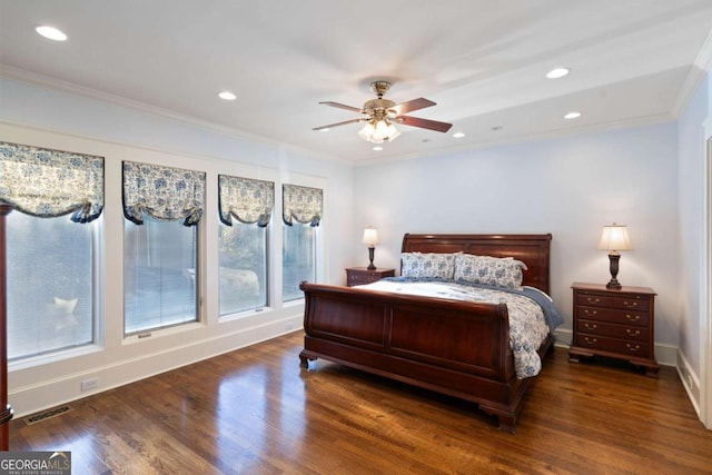 bedroom with ceiling fan, ornamental molding, dark wood-type flooring, and multiple windows