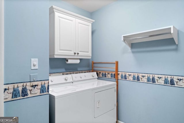 laundry area featuring washer and dryer and cabinets