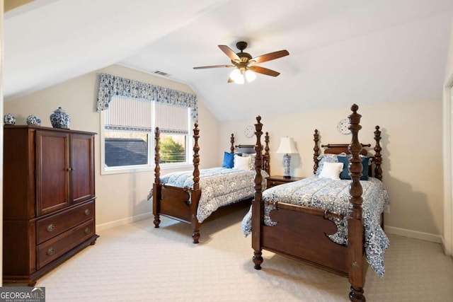 bedroom featuring ceiling fan, light colored carpet, and vaulted ceiling