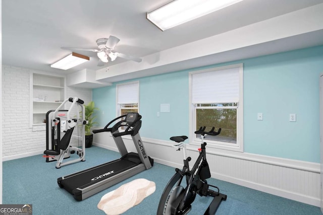 exercise area featuring ceiling fan and built in features