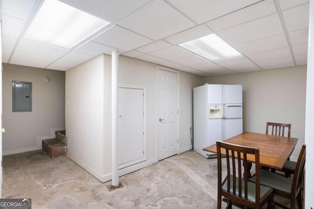 dining room featuring a drop ceiling and electric panel