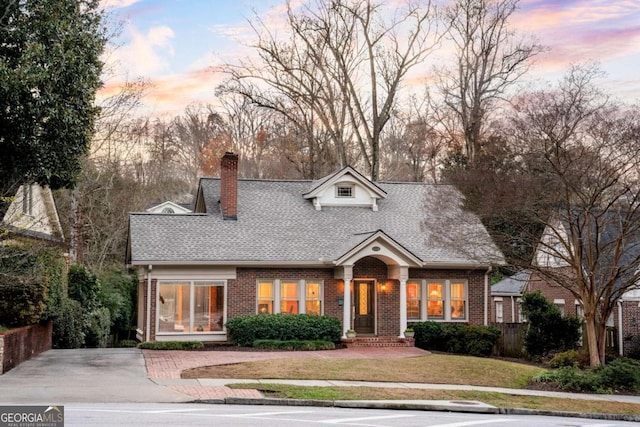 cape cod-style house featuring a yard