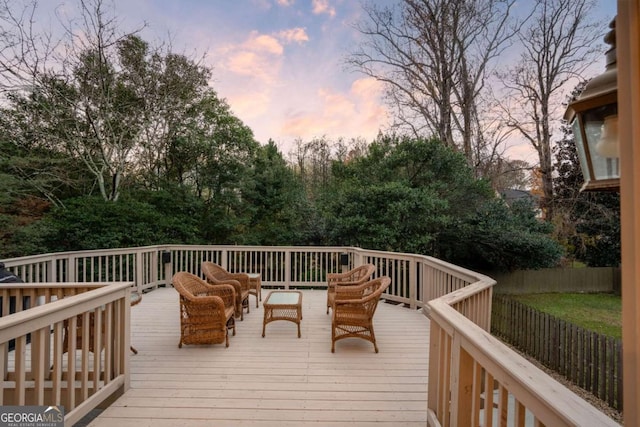 deck at dusk featuring an outdoor hangout area