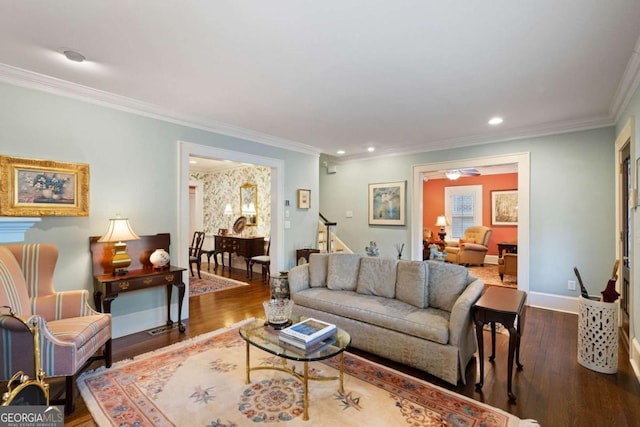 living room with crown molding, dark hardwood / wood-style flooring, and ceiling fan