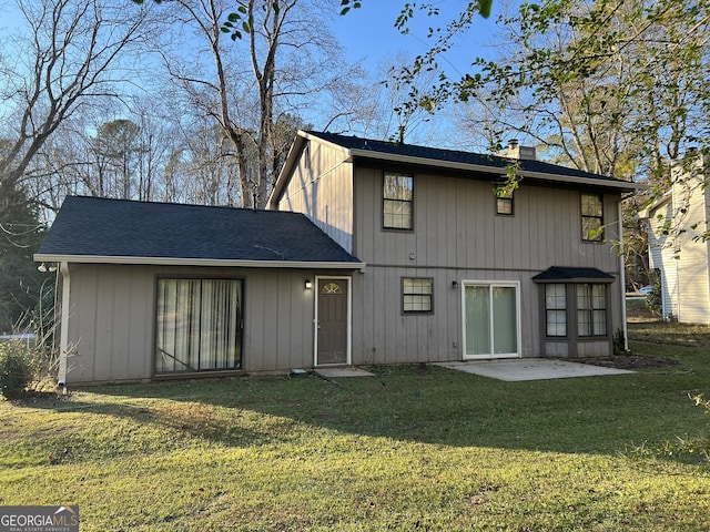 rear view of property with a yard and a patio