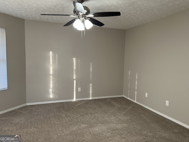 carpeted spare room with ceiling fan and a textured ceiling