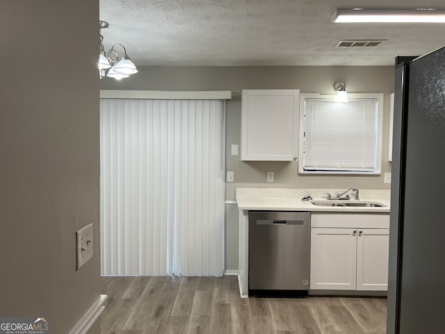 kitchen featuring stainless steel appliances, sink, light hardwood / wood-style flooring, white cabinets, and hanging light fixtures