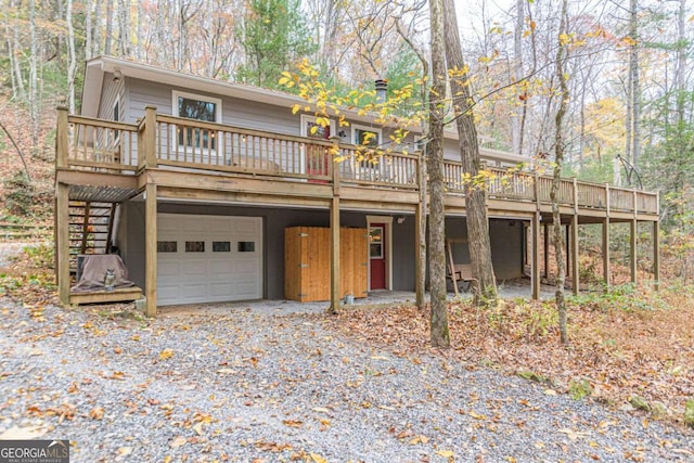 view of front property with a deck and a garage