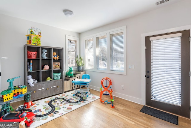 playroom with wood-type flooring