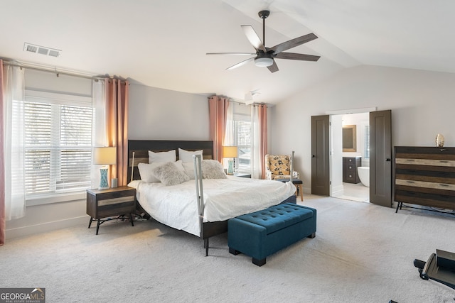 bedroom featuring ensuite bath, ceiling fan, light carpet, and lofted ceiling