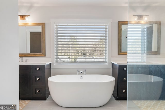 bathroom featuring tile patterned floors, a bathtub, and vanity