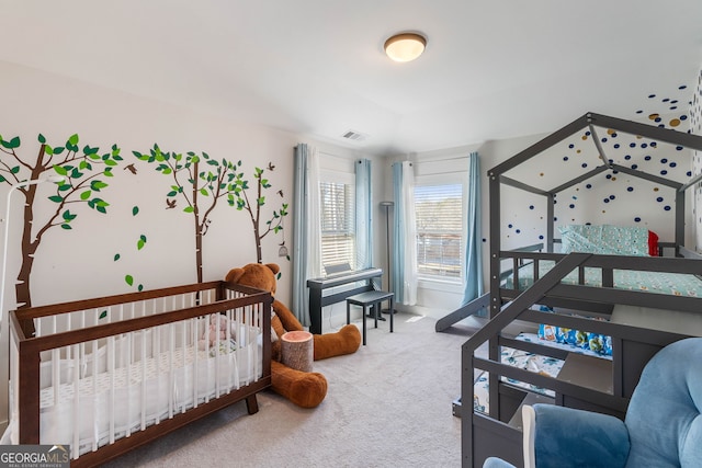 bedroom with carpet and a crib