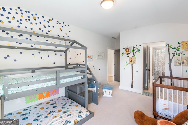 carpeted bedroom with a nursery area