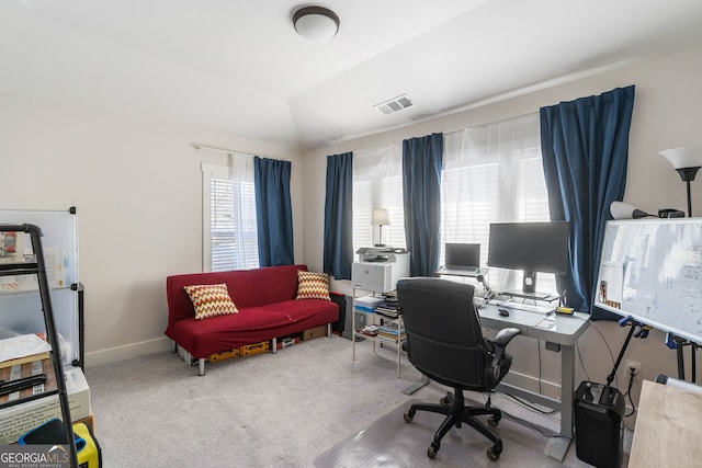 carpeted office featuring lofted ceiling