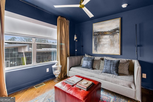 living room with hardwood / wood-style flooring and ceiling fan