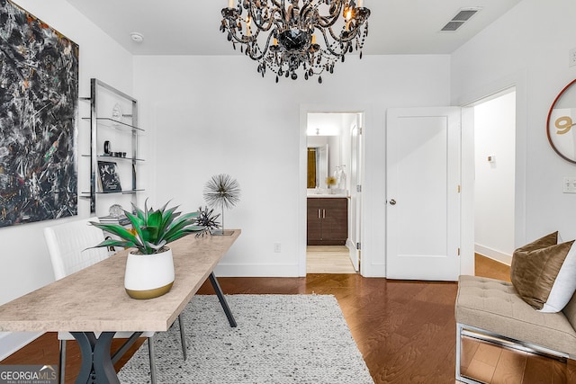 home office featuring hardwood / wood-style flooring and a notable chandelier