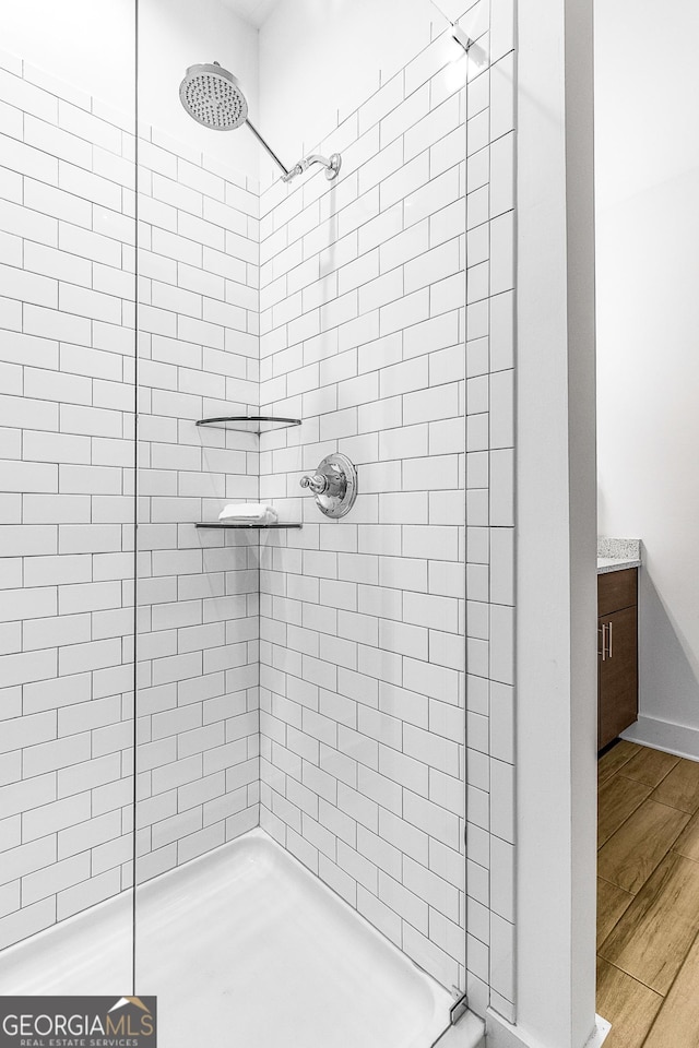 bathroom featuring vanity and a tile shower