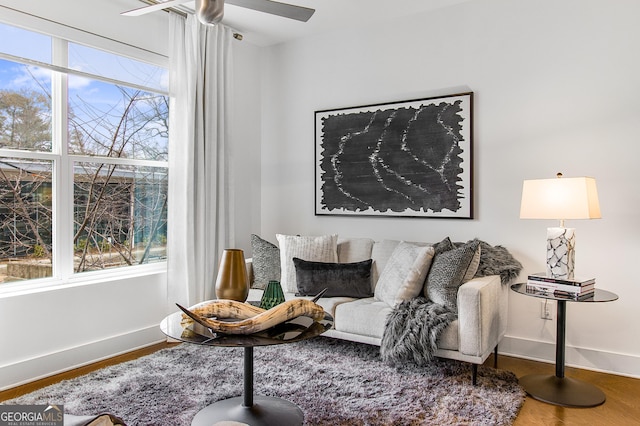 living area featuring ceiling fan and wood-type flooring