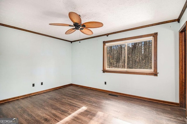 empty room featuring hardwood / wood-style floors, ceiling fan, ornamental molding, and a textured ceiling