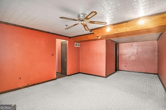 unfurnished room featuring ceiling fan, carpet floors, and crown molding