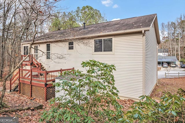 back of property featuring a wooden deck