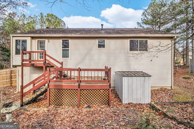 rear view of house featuring a wooden deck