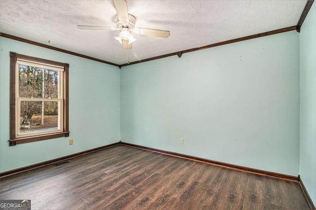 spare room with ceiling fan, dark hardwood / wood-style flooring, ornamental molding, and a textured ceiling