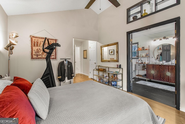 bedroom featuring ceiling fan, light hardwood / wood-style flooring, and high vaulted ceiling