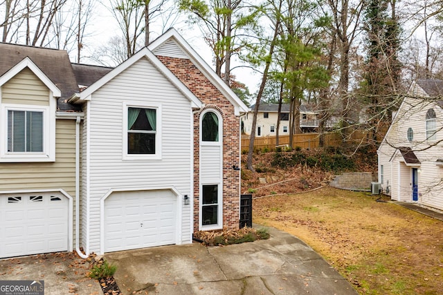 view of front of home with cooling unit and a garage