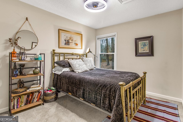 bedroom with a textured ceiling and carpet floors