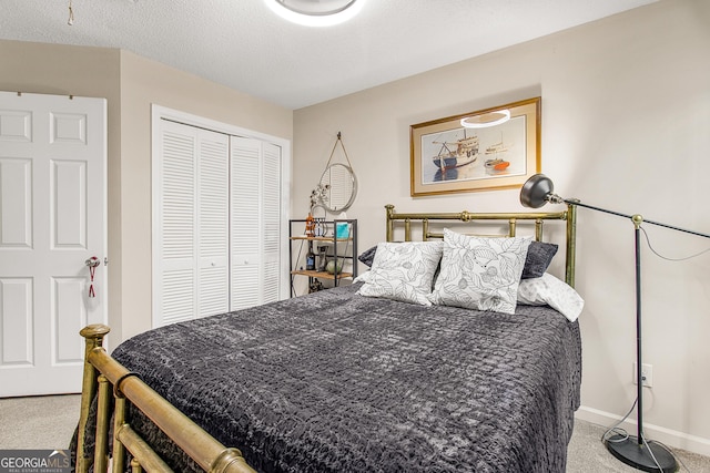 bedroom featuring a textured ceiling, light colored carpet, and a closet