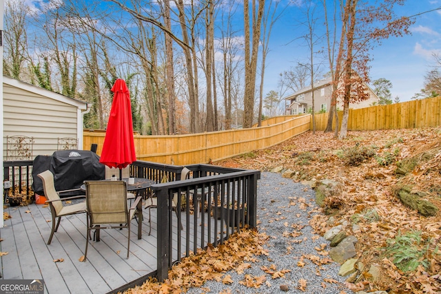 wooden deck with a grill