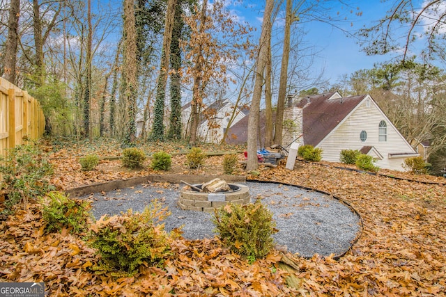 view of yard featuring an outdoor fire pit