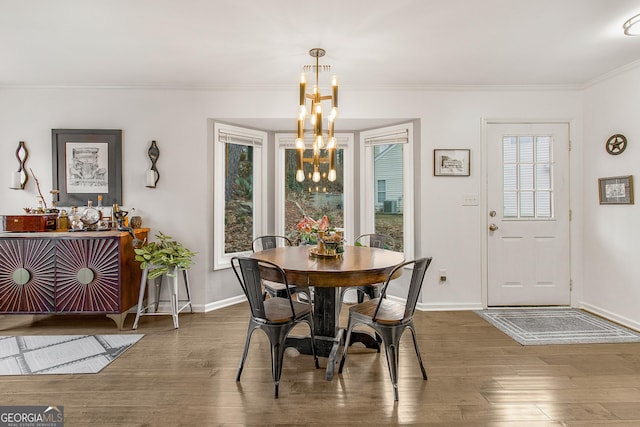 dining area featuring crown molding, a chandelier, and dark hardwood / wood-style floors