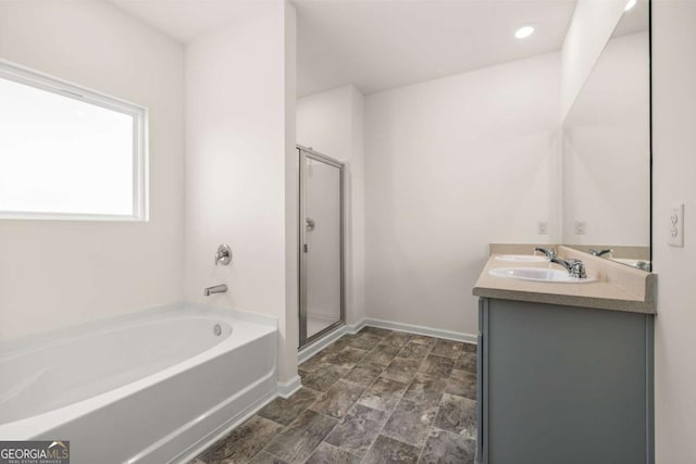 bathroom with plus walk in shower and vanity