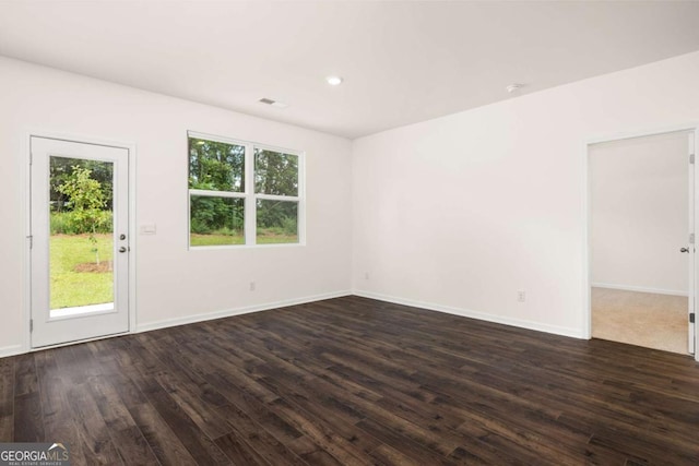 empty room featuring dark hardwood / wood-style flooring